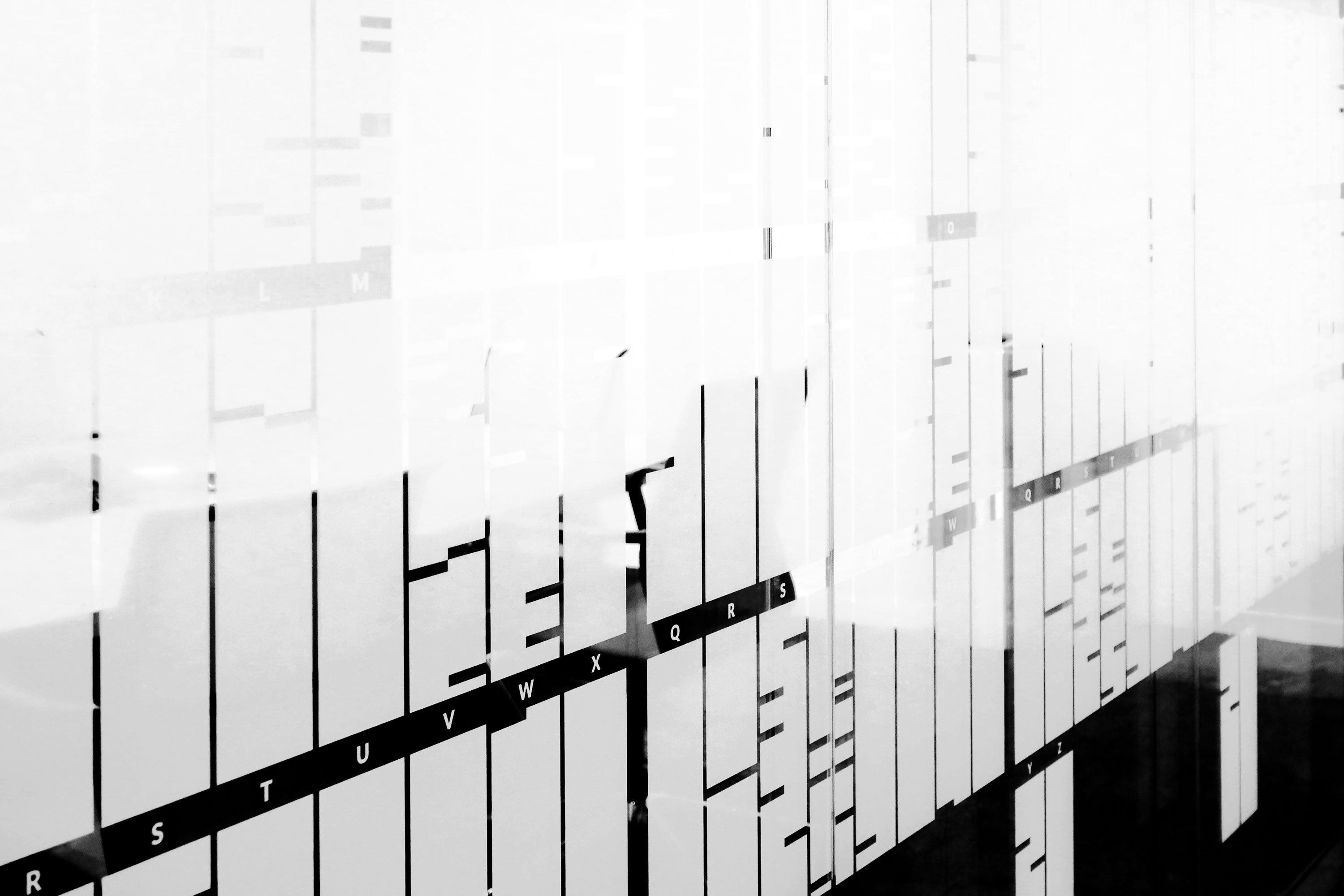 A gridded encoding system to render a Turing quotation, semitransparent, on glass.